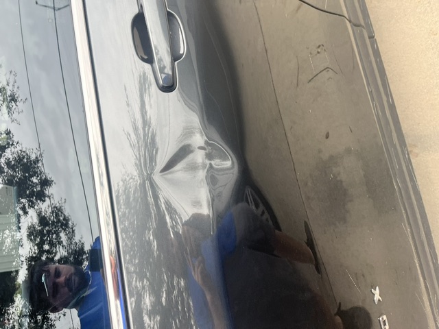 Dark door panel with a deep crease beneath the window