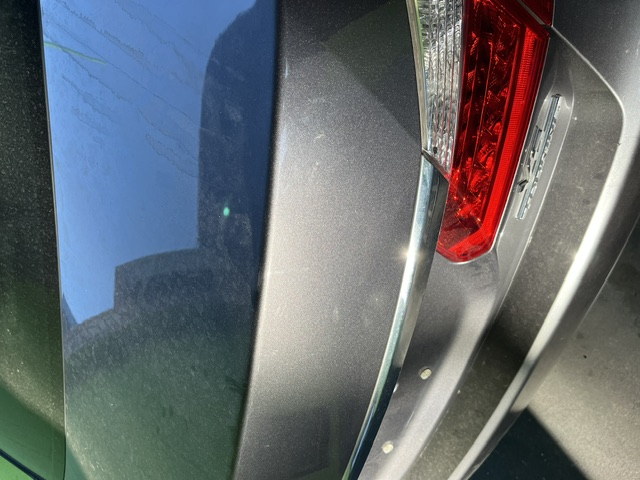 Gray trunk panel after repair beside the taillight
